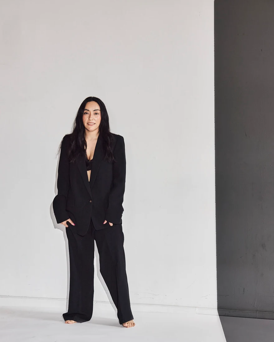 Lili in a black suit, in the studio — photograph 5475